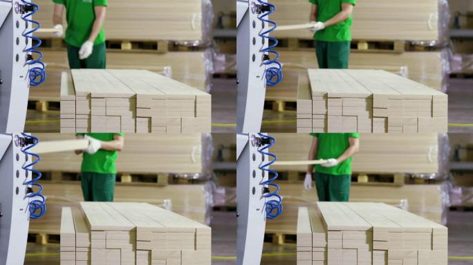 一个穿着制服的人在家具厂的木工机器上工作。4K