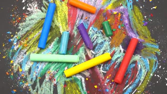 彩色蜡笔位于它们绘制的抽象背景上。