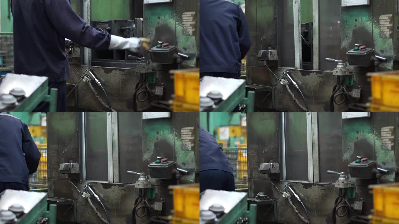 操作员正在使用生产线上的机器，努力工作的工业工人