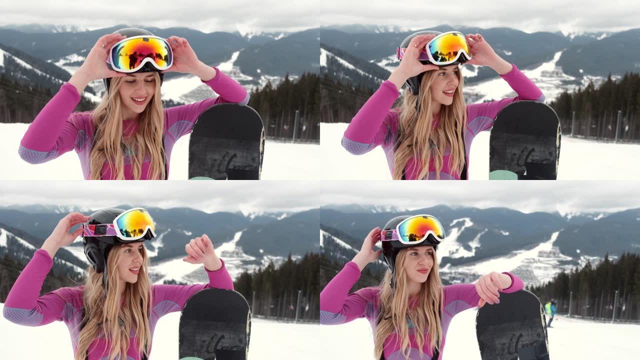年轻女孩滑雪者在山顶上微笑