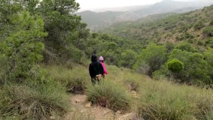 徒步旅行者在山区森林和小径上集体行走。一群人在山地徒步旅行。健康运动员锻炼徒步旅行