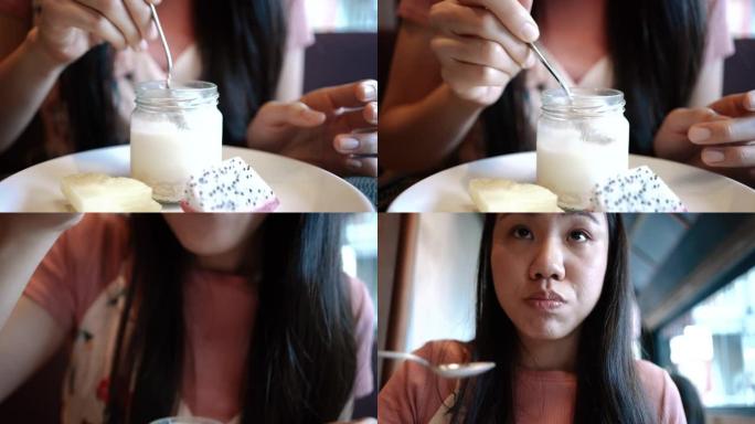 一个年轻女人在吃食物的特写镜头。