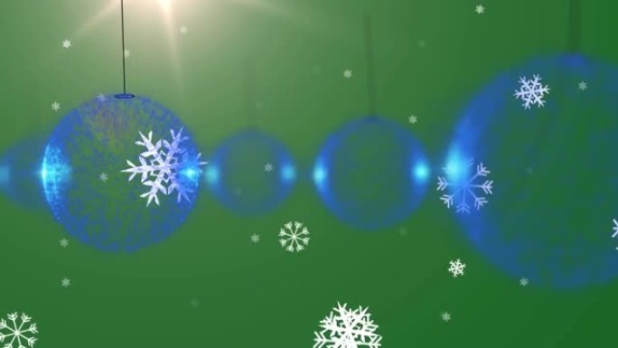圣诞蓝色小玩意装饰落在绿色背景上的雪的动画