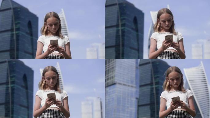 专注的少女在发达城市的玻璃摩天大楼背景上阅读智能手机。美丽的年轻女孩在城市景观上从手机上浏览社交网络
