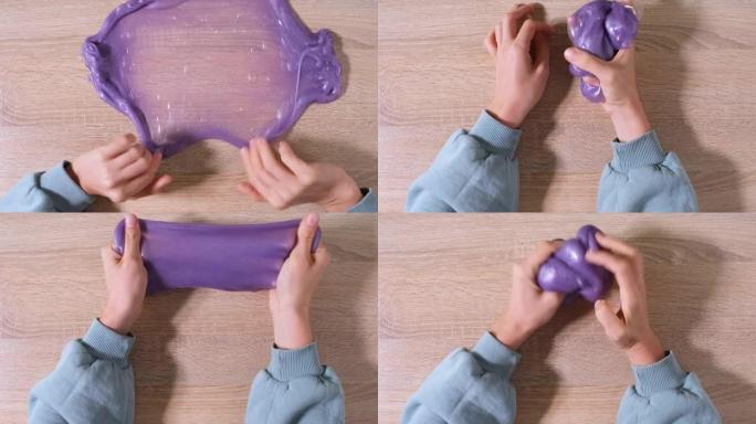 玩粘液，拉伸粘稠物质以获得乐趣和缓解压力。特写和俯视图的女性手拿着紫色闪亮的粘液并挤压它。4k视频。