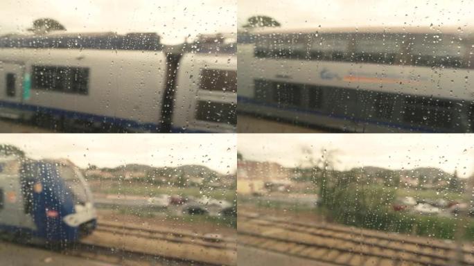 从湿火车窗口观看。