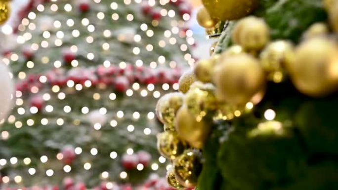 节日装饰的室内圣诞发光二极管灯的特写镜头，模糊的闪闪发光的童话背景上有明亮的金色球。