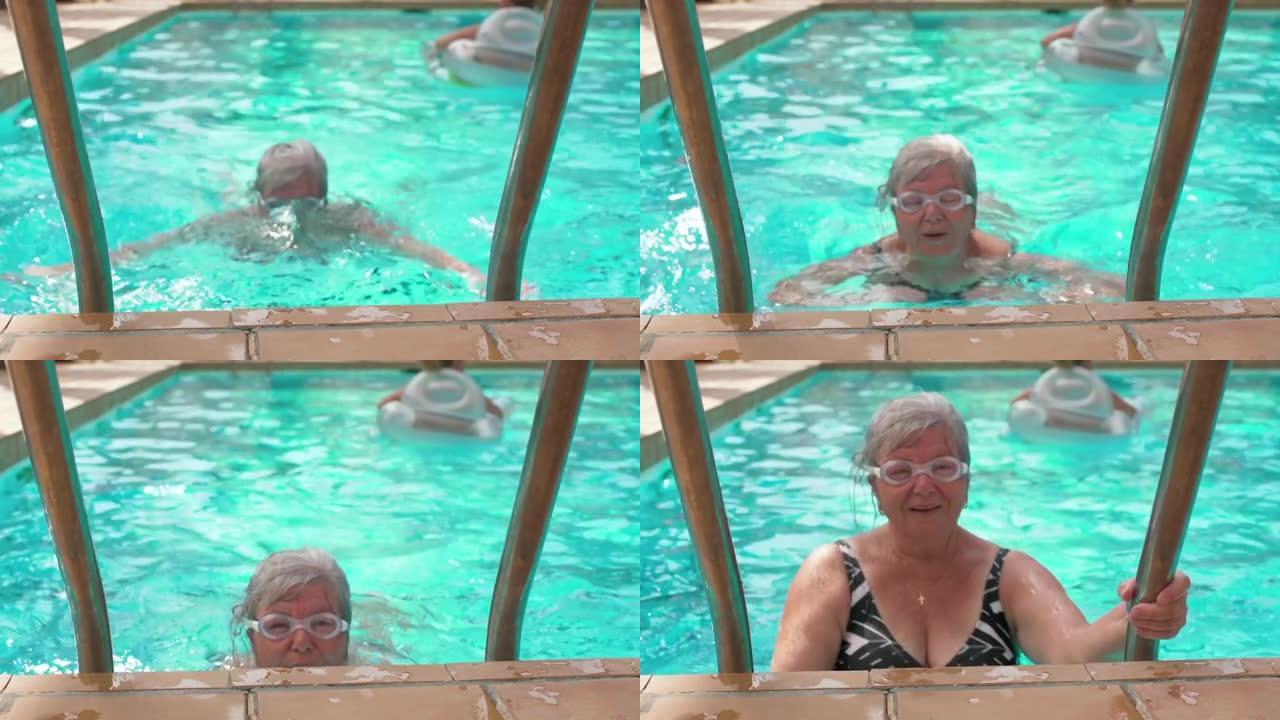 灰白头发的老年妇女在酒店游泳池游泳，眼睛上有谷歌，靠近时微笑着满足