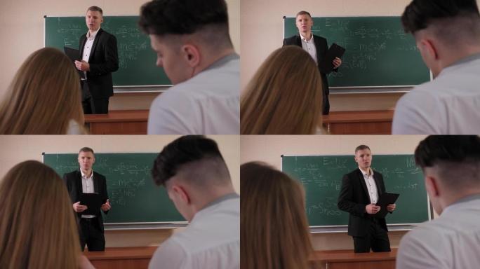大学的一位老师站在黑板旁，与学生交谈。