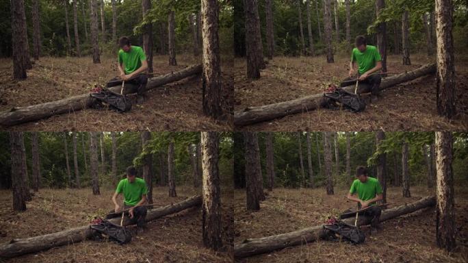 一个徒步旅行者在森林里用干燥的树林建造一个避难所