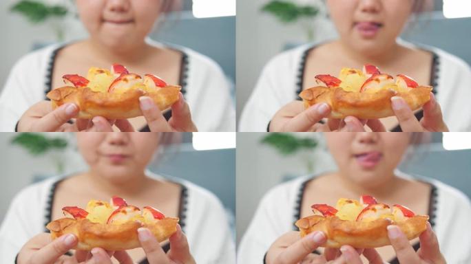 特写丰满的亚洲女人带着欲望看着披萨的嘴