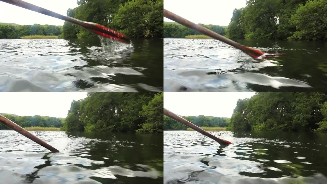 用旧木桨划过清澈的湖面