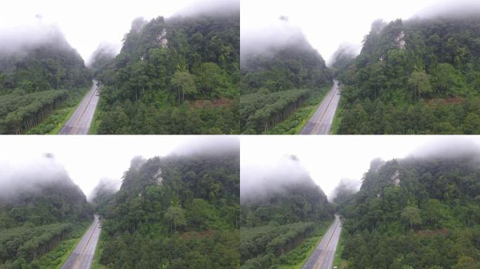 通过带有雾的局部山脉的道路的鸟瞰图