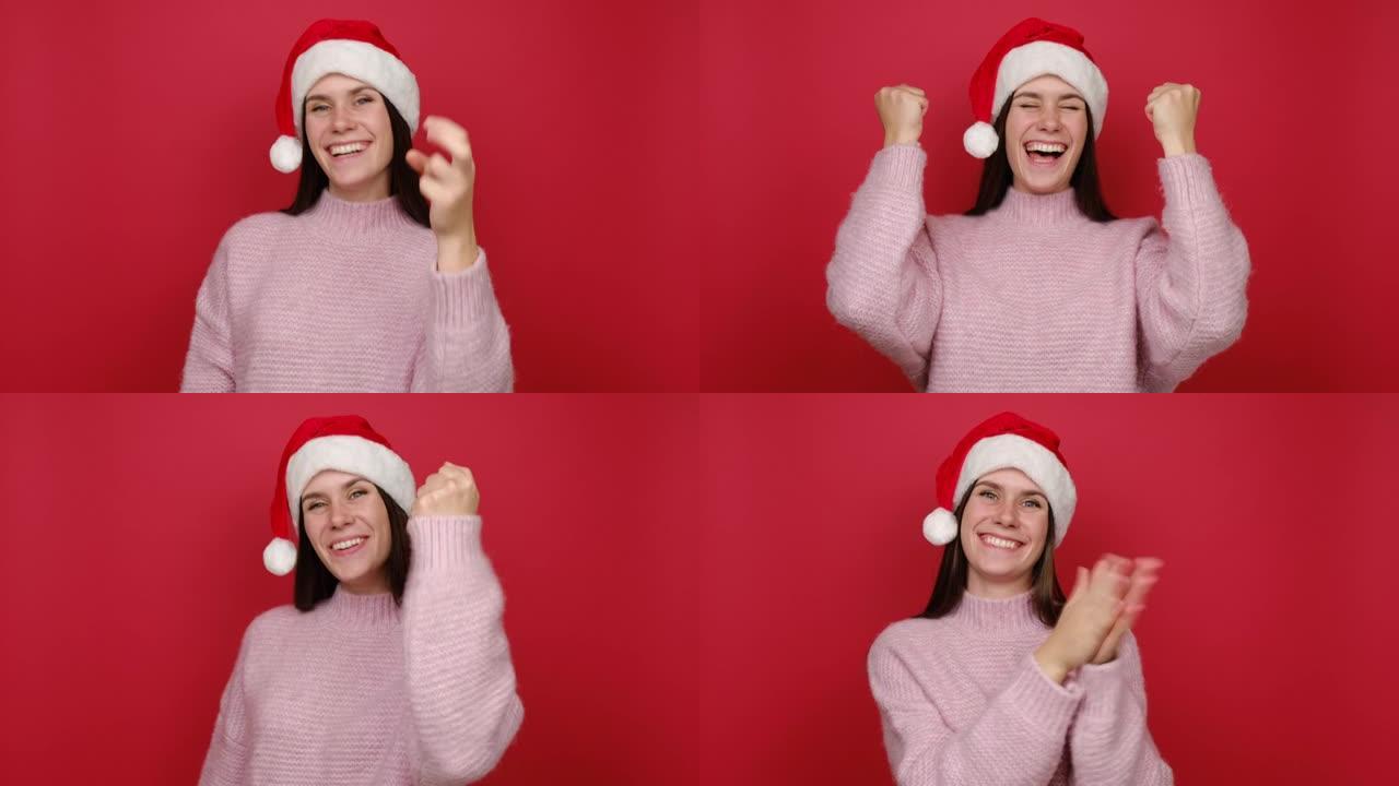 有趣的快乐年轻圣诞老人女人20多岁，穿着粉色毛衣和圣诞帽倒计时1 2 3去庆祝胜利尖叫握紧拳头，在红