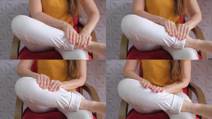 女性双手在小腿上进行自我按摩的细节