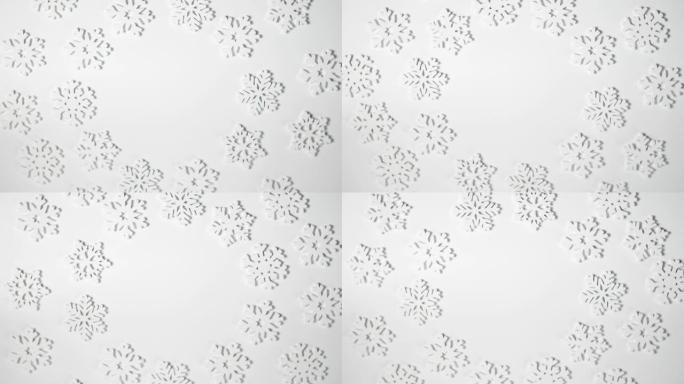 圣诞玩具白色雪花框架在白色背景上旋转，并放置文字。新年作文视频贺卡4k镜头