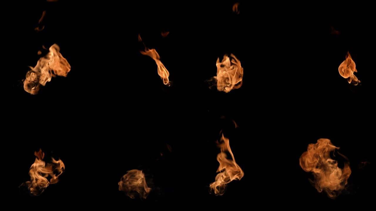 黑色背景上的火和火焰慢动作视频。黑暗中的熊熊大火。明亮燃烧的火焰特写。炽热的篝火。高速喷火器用火焰爆
