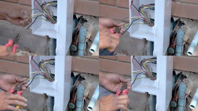手动关闭-亚洲空调技术人员为空调安装制造了不充分的电线。家庭装修和翻新概念中的不当安全。