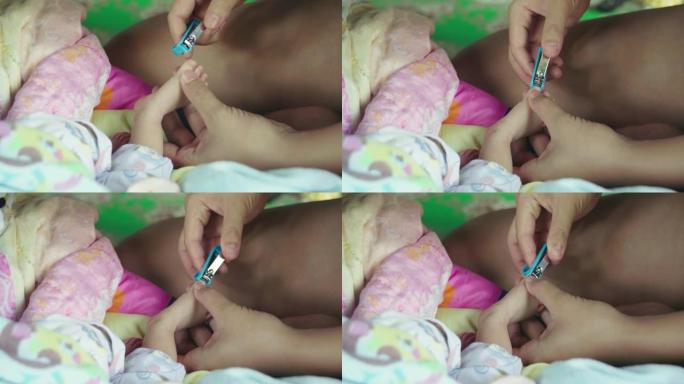 妈妈用专用剪刀剪婴儿指甲。