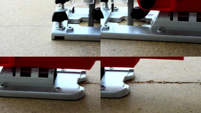 一个木匠用电动跳汰机锯一块胶合板布。工作指锯特写。木匠建筑商使用电动拼图和胶合板。