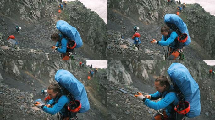 一名攀岩者用绳子爬到落基山脉的山顶。