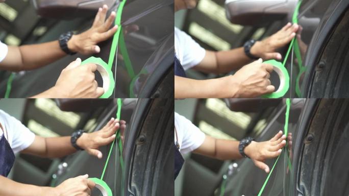 在抛光汽车细节之前，铜手在汽车表面使用绿色遮蔽胶带