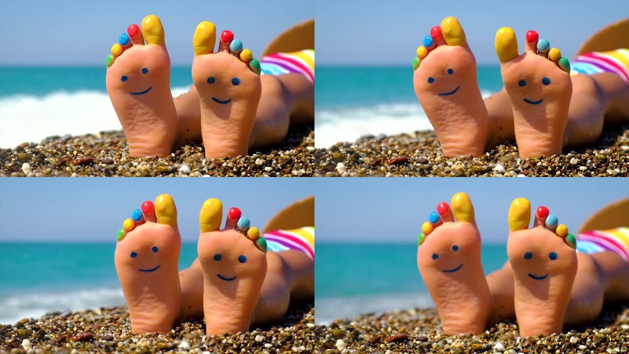 孩子的脚在海滩上画了一个微笑。选择性聚焦。孩子。