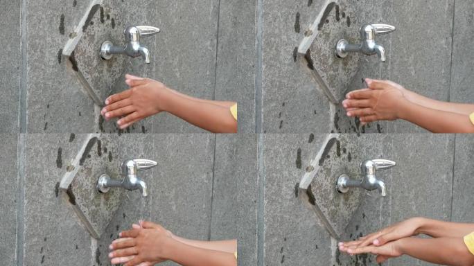 印尼小男孩的手正在洗手