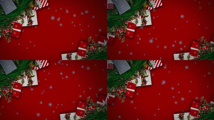 雪花落在红色背景下的圣诞花环装饰和礼物上