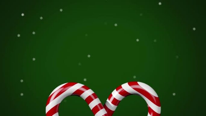 绿色背景上的圣诞节糖果上的雪的动画