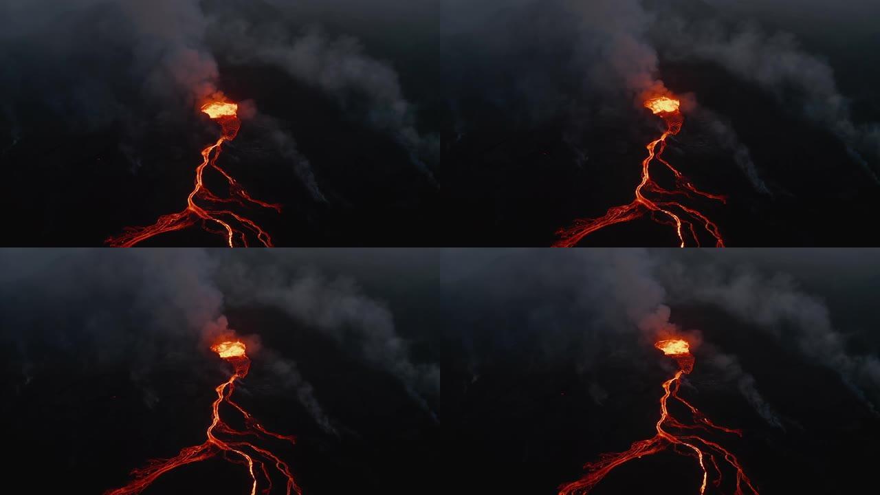 夜间活火山的鸟瞰图。分支熔岩流从火山口流出的沸腾岩浆。法格拉达尔斯福杰尔火山。冰岛，2021