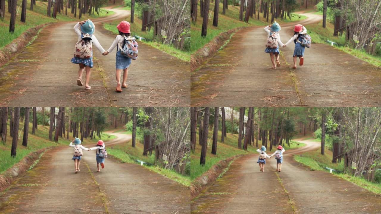 两个小姐妹互相牵着手，在晴天沿着松林路往前跑。