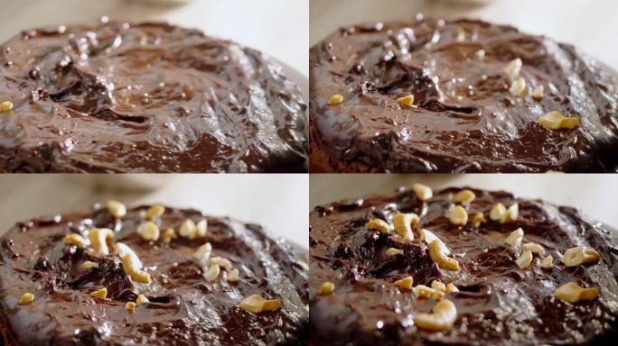 自制巧克力甘纳切蛋糕上的腰果，慢动作。