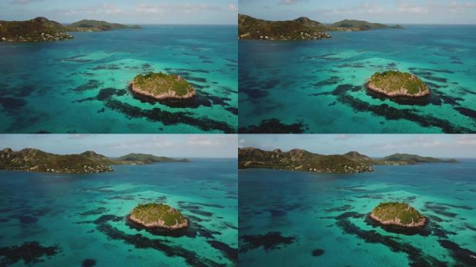 环绕加勒比海礁的空中无人机视图，背景上出现了一个主要岛屿