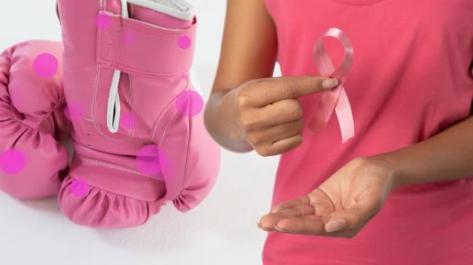 混合白种人的动画持有粉红色的丝带和粉红色的拳击手套在白色的背景