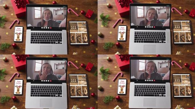 快乐的高加索高级女性视频通话，智能手机，平板电脑和圣诞节装饰品