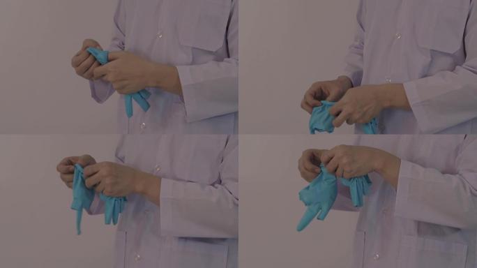戴着手套。男医生戴蓝色橡胶丁腈手手套。医生戴上手套的镜头。孤立的白色背景复制空间。医疗保健保护冠状病