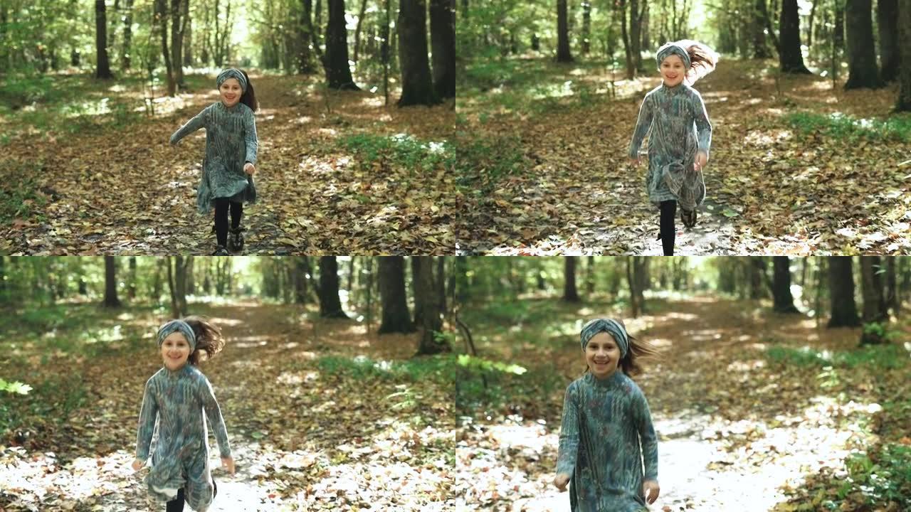快乐的小孩，在公园森林里笑着玩着秋天的落叶。腿在秋天的多色枫叶上行走