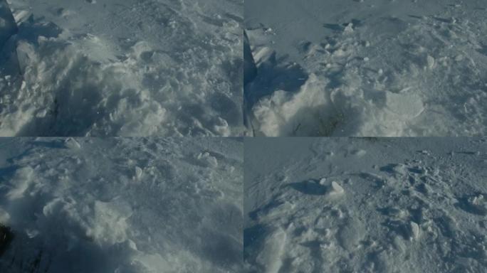 一个人走在雪白的冰上。靴子踢着雪。美丽的冬天的风景。俄罗斯的自然地标。前视图。缓慢的运动。