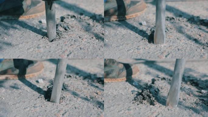 手提钻特写。手提钻特写。手提钻破坏了沥青。手提钻破坏了沥青