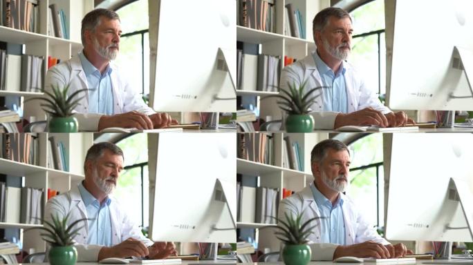 穿着制服的医学专家坐在诊所的桌子前用电脑打字工作