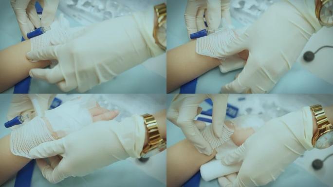 近距离拍摄护士将针头插入患者的儿童手臂并抽血进行进一步检查。4k分辨率。慢动作。