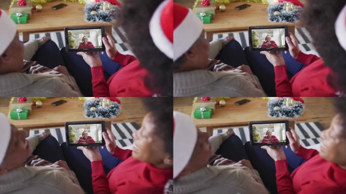 非裔美国母亲和女儿使用平板电脑与屏幕上的朋友进行圣诞节视频通话
