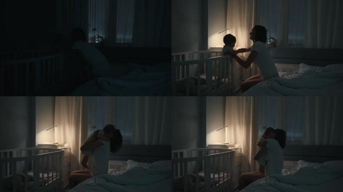 夜间拍摄的一位母亲晚上醒来时在婴儿床里哭泣的婴儿。白人新生儿蹒跚学步的孩子在孩子们的卧室里。童年，新
