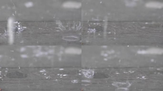 慢动作速度特写镜头雨滴落在地板上并反弹