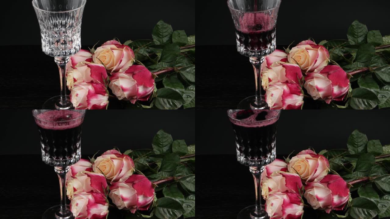 玫瑰花在黑色背景上的水晶酒杯附近