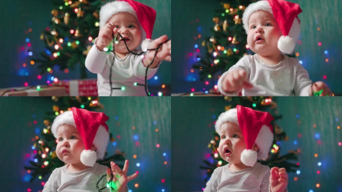 平安夜。一个戴着圣诞帽的有趣女婴的肖像，玩着节日的灯光。慢动作。新年假期的概念