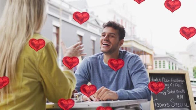 心脏图标的动画漂浮在快乐的高加索夫妇说话和微笑