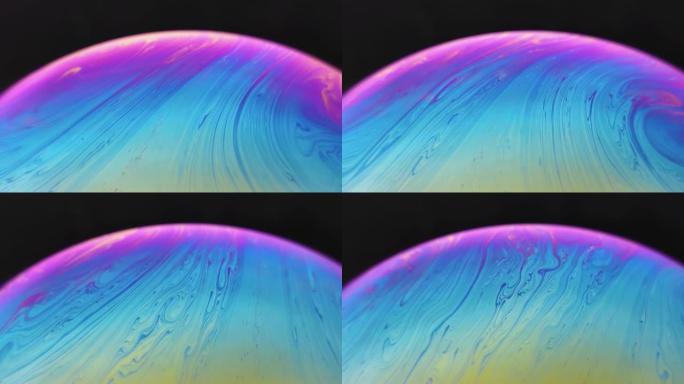 黑色背景上的肥皂泡球。抽象半圆运动彩色背景。宇宙宇宙或行星模型。真实宏视频。