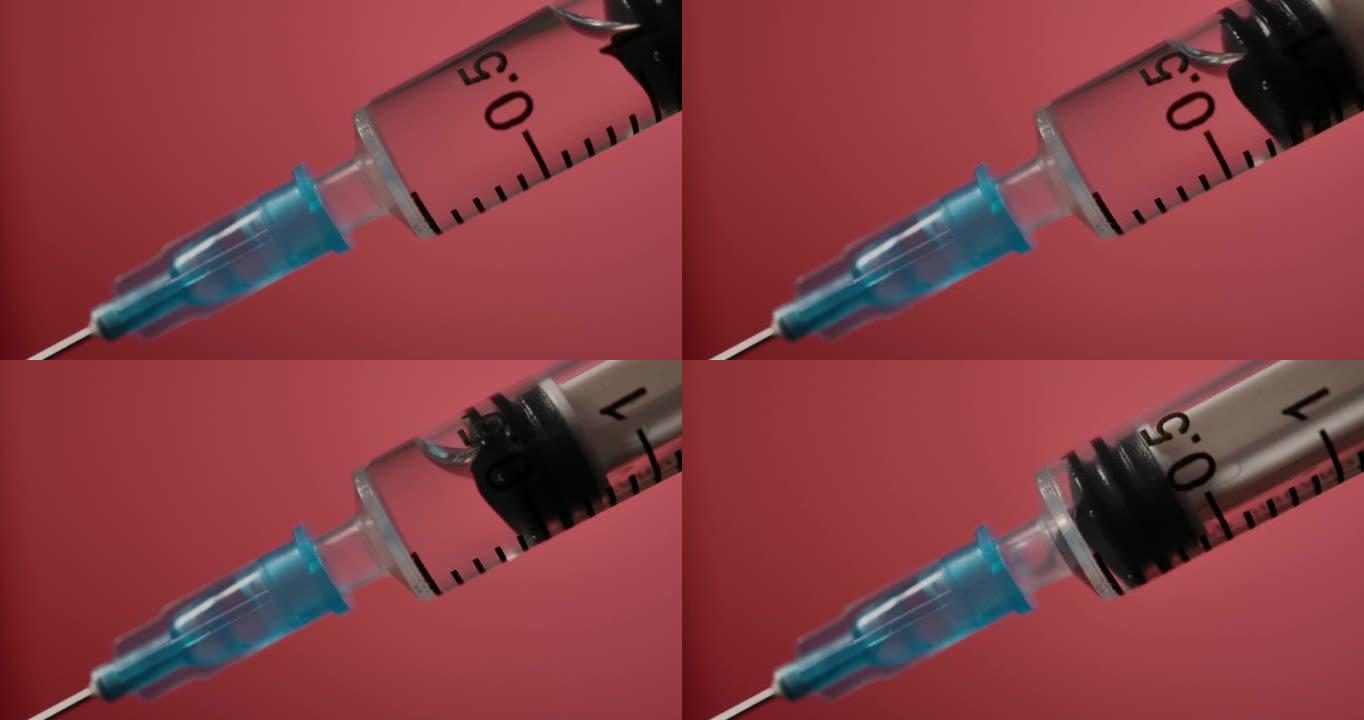 注射器中的注射液体在红色背景下的特写。药物药物针头注射器药物，流感疫苗小瓶剂量皮下注射治疗疾病预防预